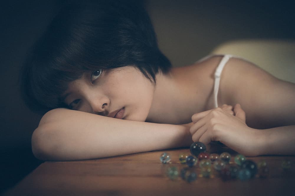 Thoughtful Girl With Marbles by Nobu Ishijima — canvas wall art