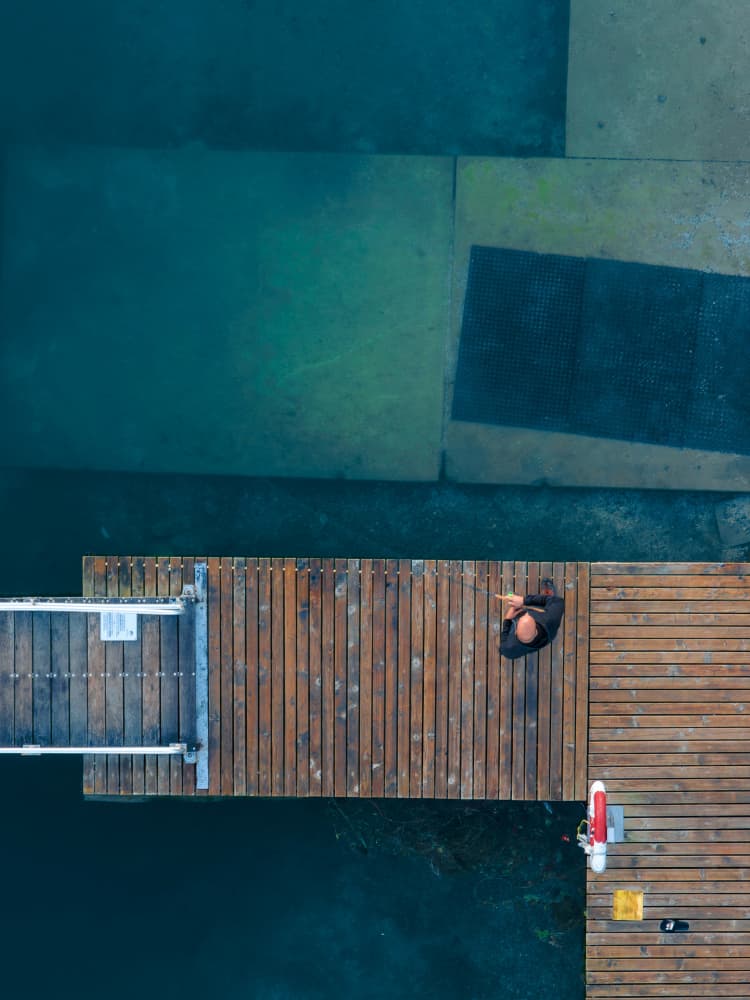Man on Wooden Dock by Jure Kravanja — canvas wall art