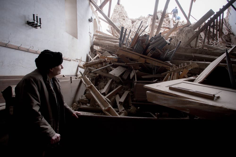 Man Views Church Rubble by ATTILA SZABO — canvas wall art