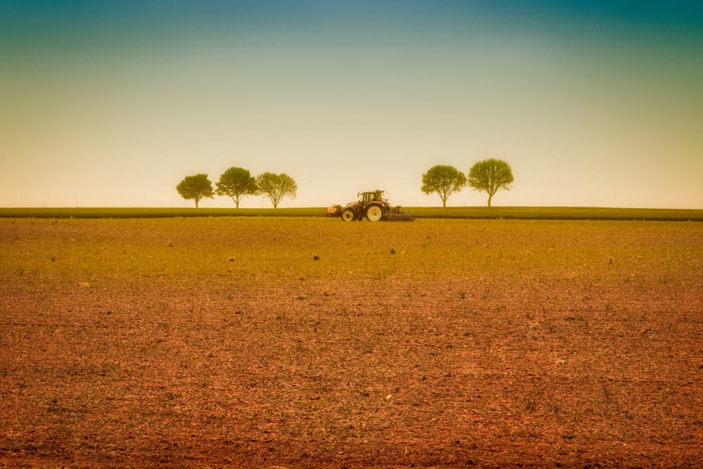 Tractor Working Vast Field by Michelle Degryse — canvas wall art