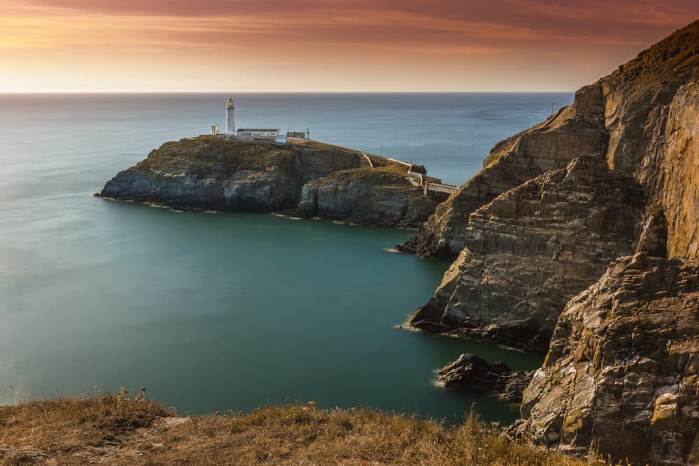 Golden Hour Lighthouse Cliffs by Hardik Pandya — canvas wall art
