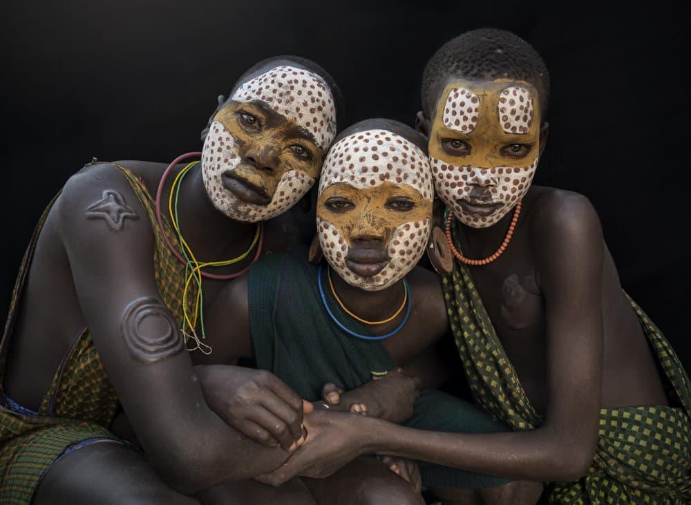 Painted Tribal Faces by Sarawut Intarob — canvas wall art