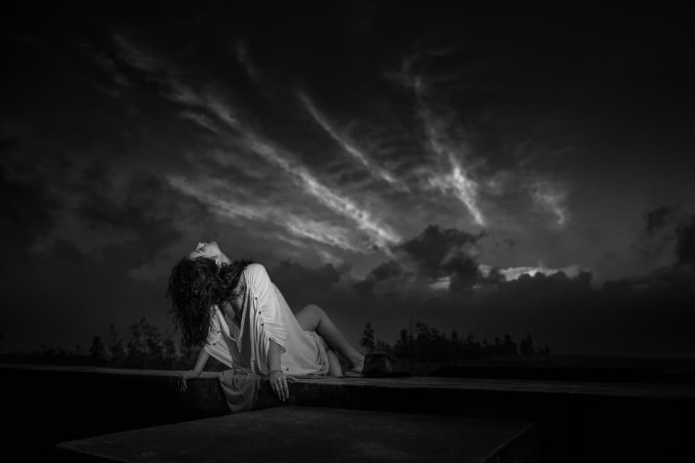 Woman Under Dramatic Sky by Songlin Xu — canvas wall art