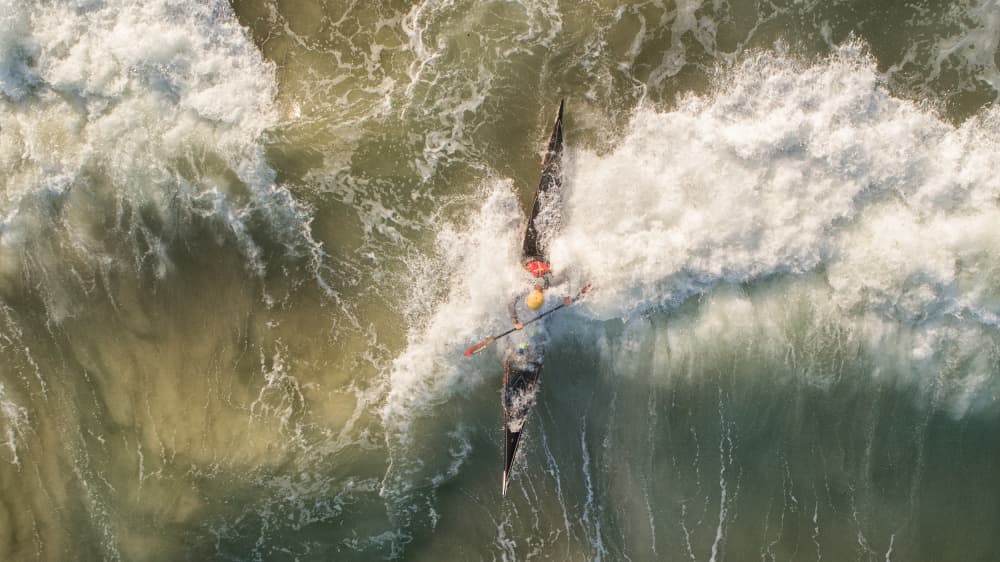 Paddler Breaking Ocean Wave by Ido Meirovich — canvas wall art