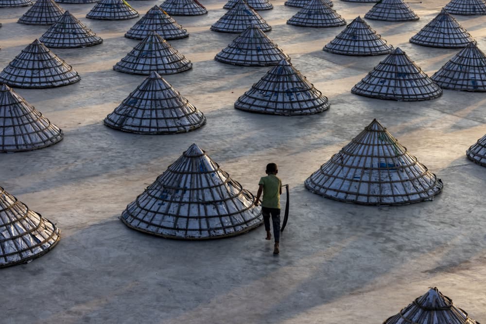 Boy in Salt Field by Azim Khan Ronnie — canvas wall art