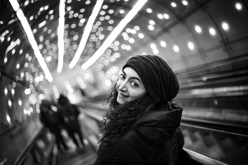Smiling Woman Escalator Lights by Waldemar Szmidt — canvas wall art