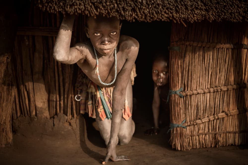Young Child From Hut by Trevor Cole — canvas wall art