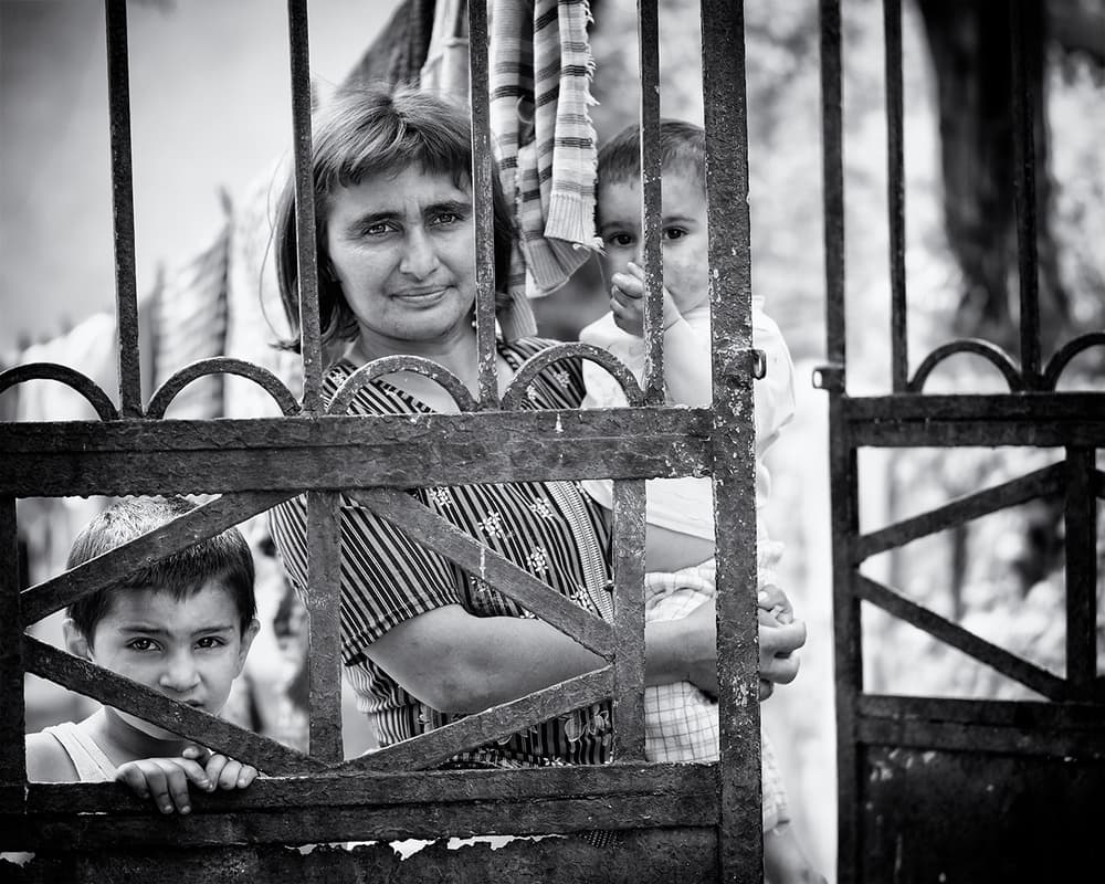 Family Through Iron Gate by Marcel Rebro — canvas wall art