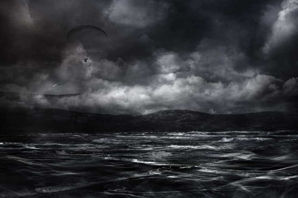 Paragliding Over Stormy Seas by Willy Marthinussen — canvas wall art
