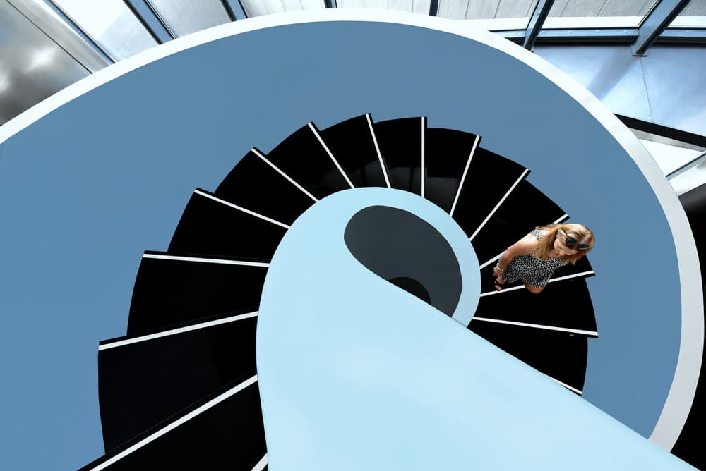 Woman Ascending Spiral Staircase by Jorge Pimenta — canvas wall art