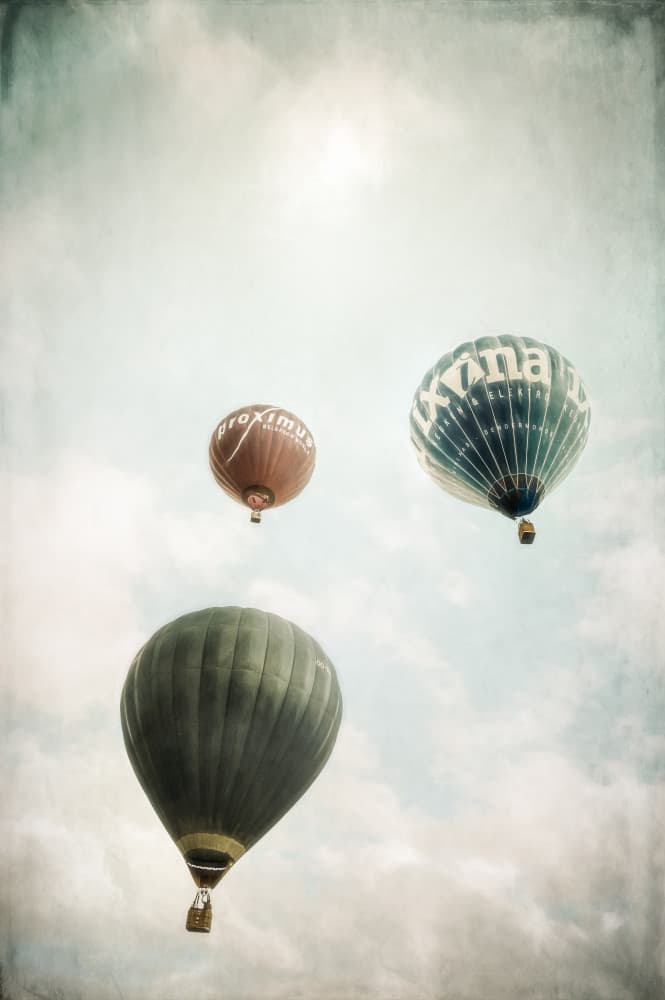 Floating Hot Air Balloons by Marc Huybrighs — canvas wall art