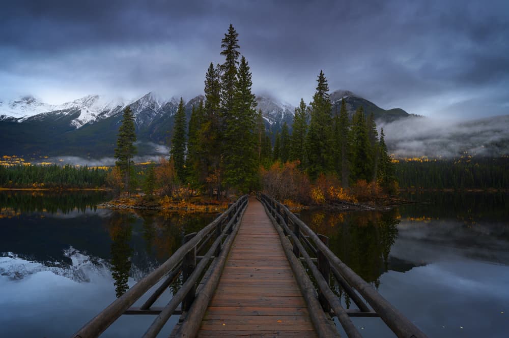 Moody Mountain Lake Bridge by David Martin Castan — canvas wall art