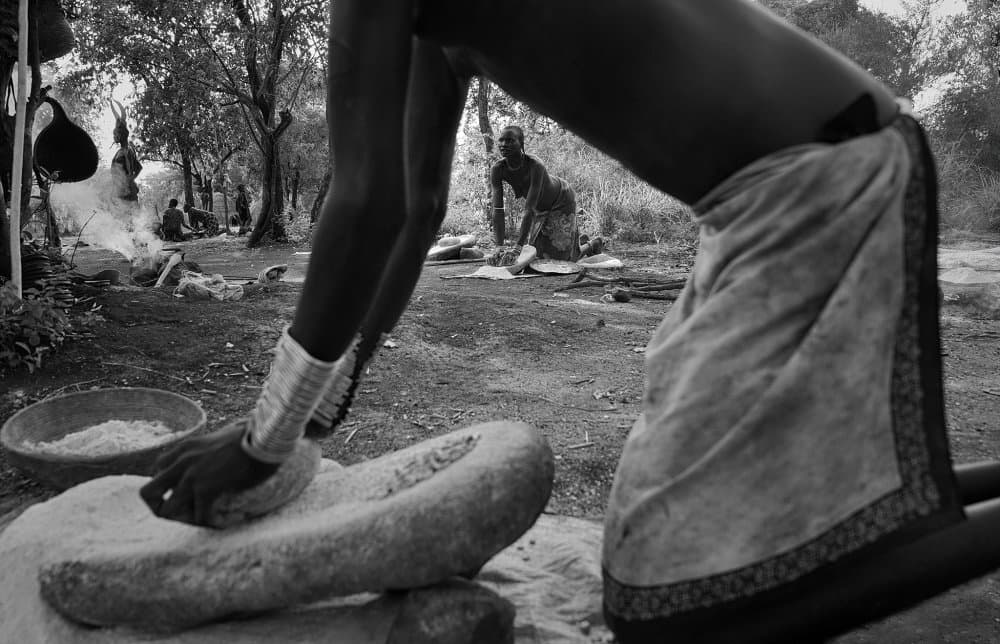 Grinding Grain Outdoors by Sarawut Intarob — canvas wall art