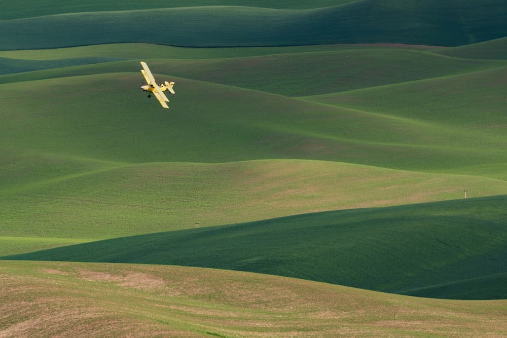 Yellow Biplane Over Green Hills by 李从军 / Austin Li — canvas wall art