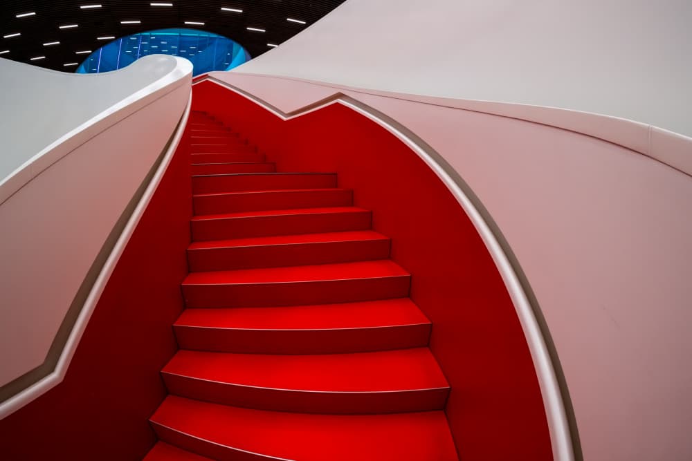 Red Curved Staircase by Martin Steeb — canvas wall art