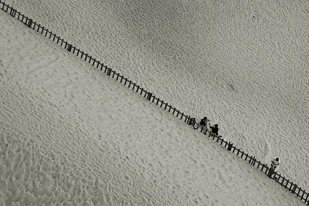 People On Desert Fence by Miguel Silva — canvas wall art