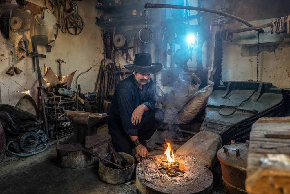 Blacksmith At The Forge by Corinne Spector — canvas wall art