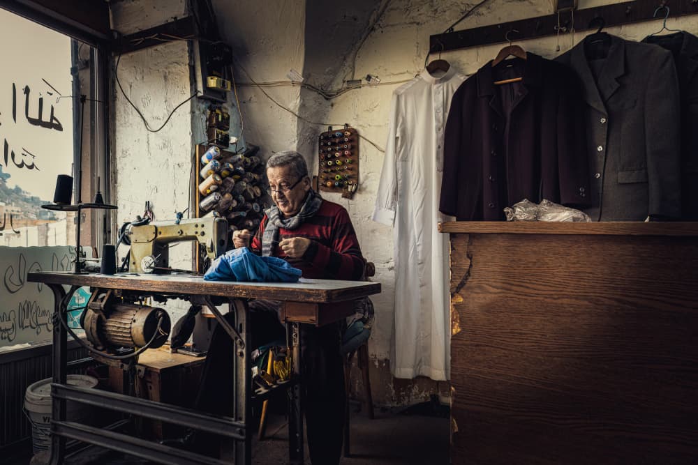 Traditional Tailor Sewing by Marco Tagliarino — canvas wall art