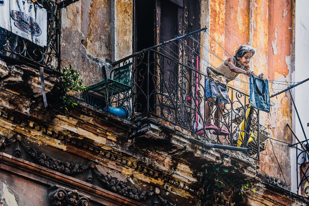 Girl Hanging Laundry Balcony by Marco Tagliarino — canvas wall art