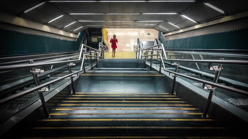 Red Dress Subway Ascent by Bego Amare — canvas wall art