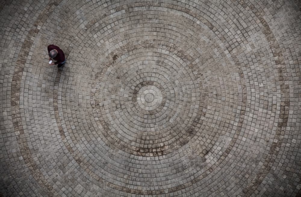 Man on Concentric Cobblestones by Tomer Eliash — canvas wall art