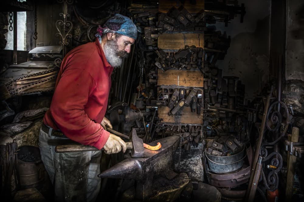 Artisan Forging Metal by Martine Benezech — canvas wall art