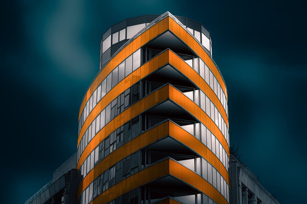 Dynamic Orange Building by Marc Huybrighs — canvas wall art