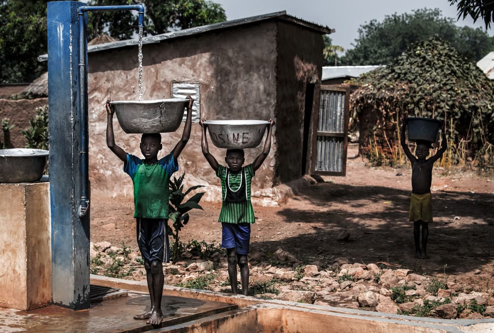 African Children Fetching Water by Joxe Inazio Kuesta Garmendia — canvas wall art