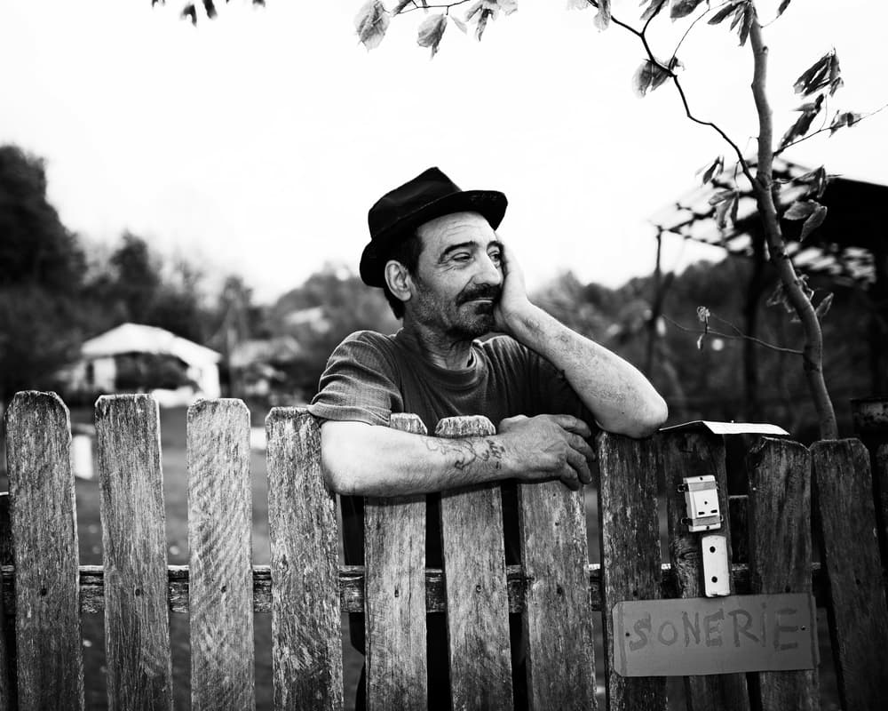 Smiling Man by Fence by Julien Oncete — canvas wall art