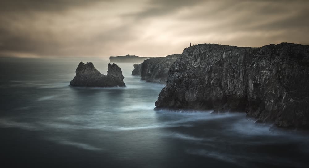 Moody Coastal Solitude by Juan I. Cuadrado — canvas wall art