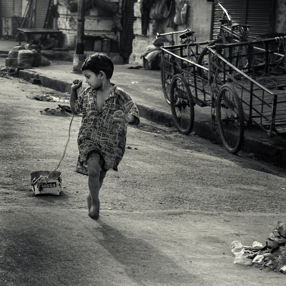 Street Child with Pull Toy by Thomas Siegel — canvas wall art