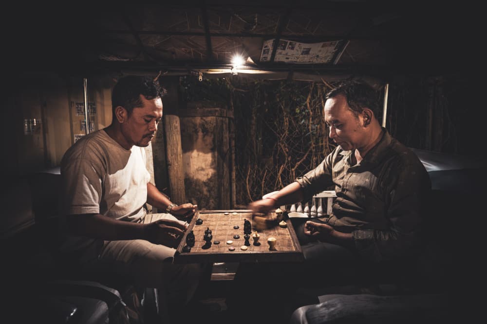 Men Play Chess at Night by Marco Tagliarino — canvas wall art