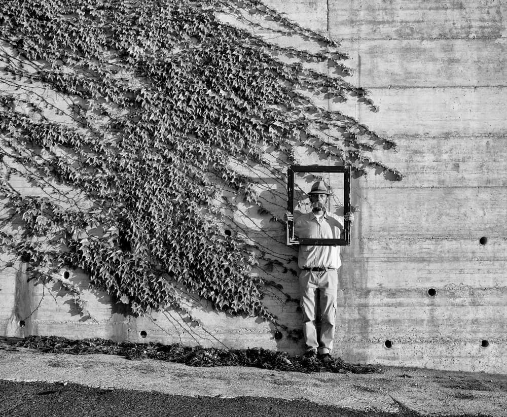 Man Holds Empty Frame by Carlo Ferrara — canvas wall art