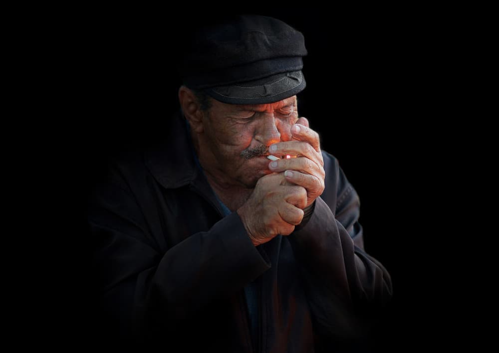 Old Man Lighting Cigarette by Emanuel Papamanolis — canvas wall art