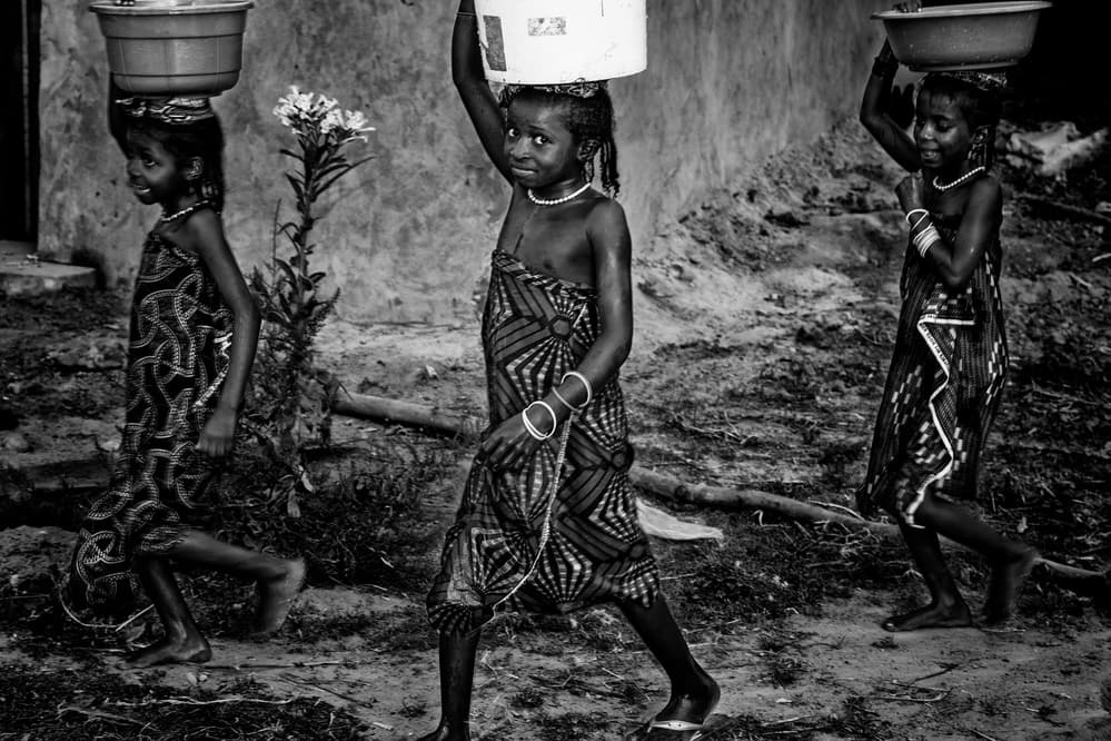 African Girls Carrying Water by Joxe Inazio Kuesta Garmendia — canvas wall art