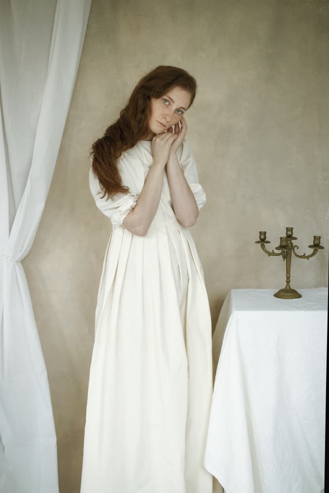 Pensive Woman In White by Raluca Arhire — canvas wall art