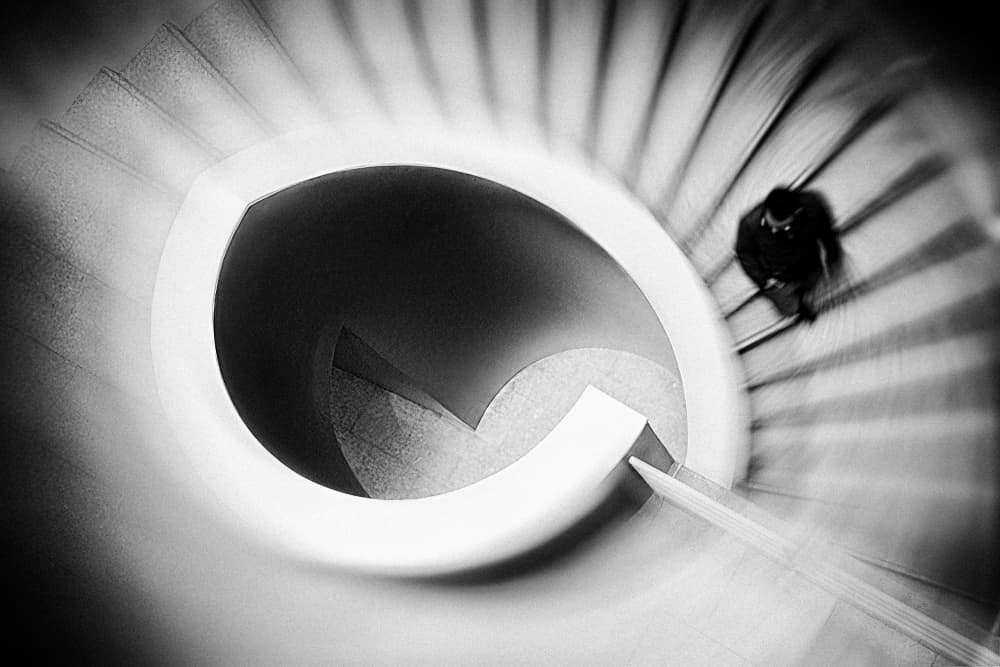 Man Descending Spiral Stairs by Ina Tänzer — canvas wall art