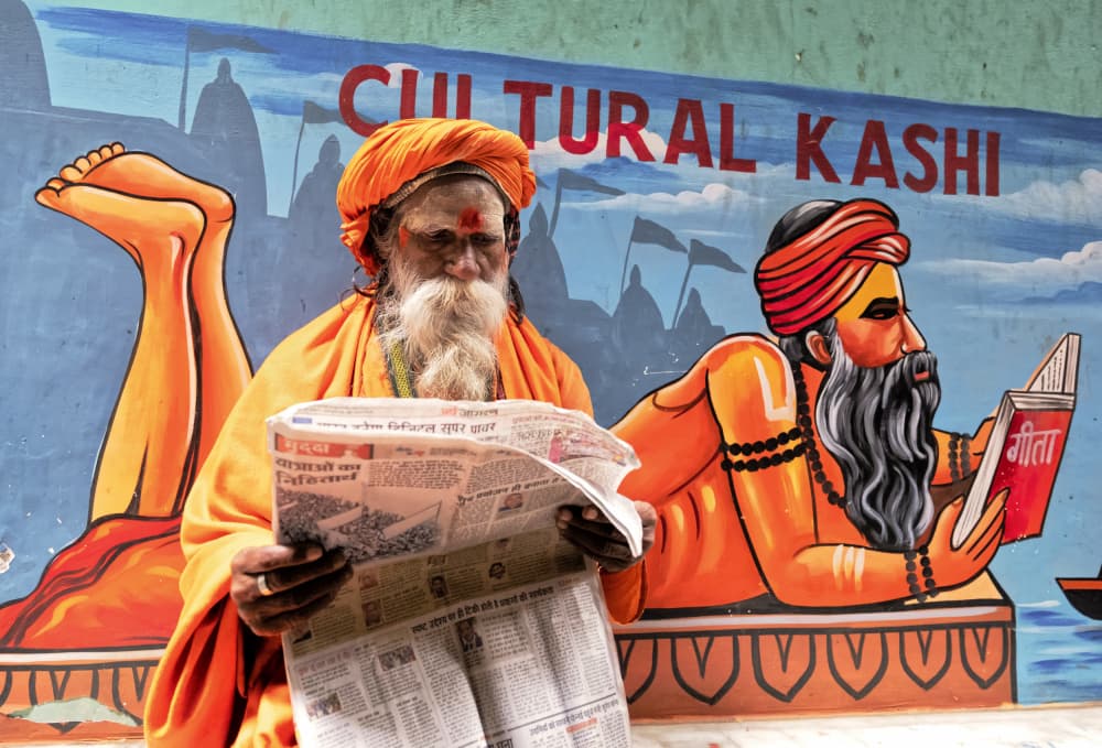 Indian Sadhu Reading Newspaper by Ajit Kumar Majhi — canvas wall art