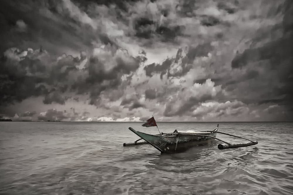 Boat Beneath Stormy Sky by Þorsteinn H. Ingibergsson — canvas wall art
