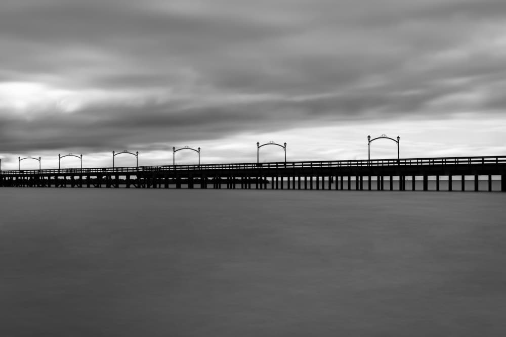 Moody Pier Horizon by Lynann Colligan — canvas wall art