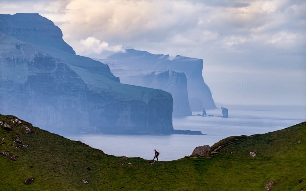 Hiker On Dramatic Coastline by James Zhen Yu — canvas wall art