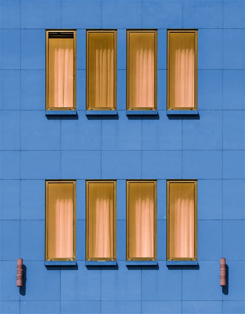 Blue Facade Orange Windows by Jef Van den Houte — canvas wall art