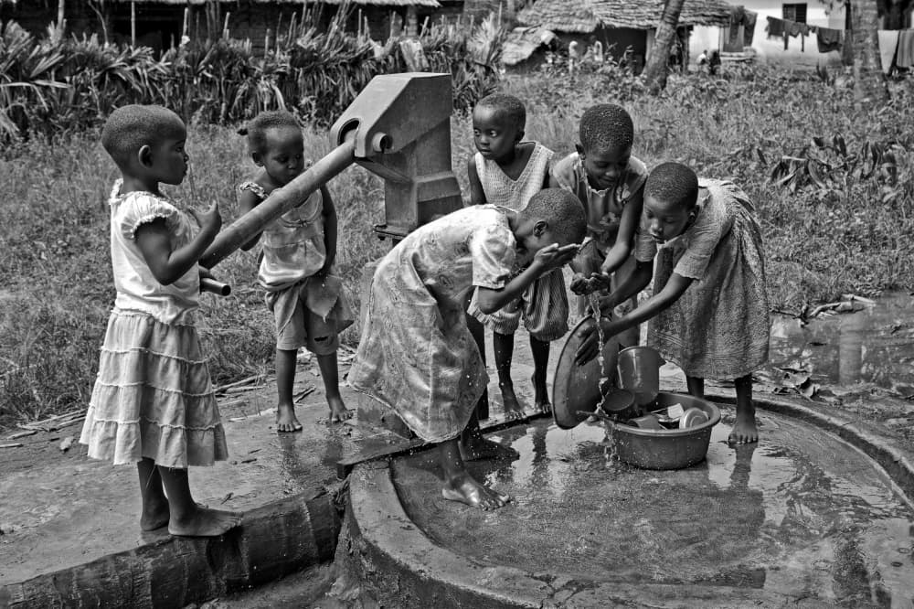 Children at Water Pump by Foad Mirzaie — canvas wall art