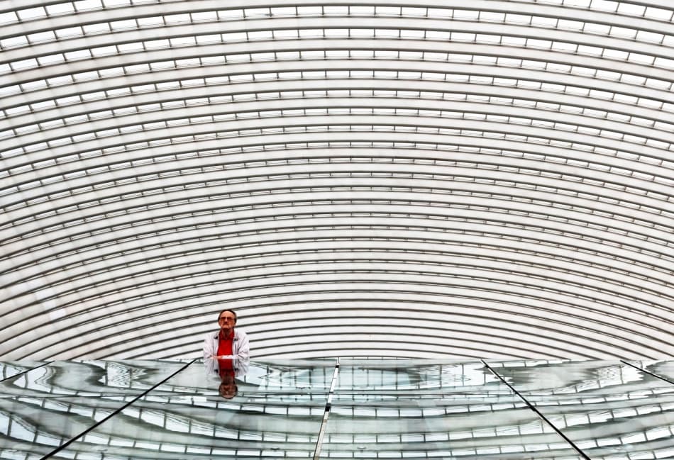 Man in Architectural Reflection by Michel Guyot — canvas wall art