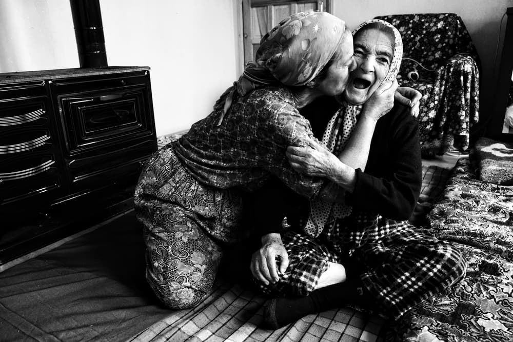 Joyful Elderly Embrace by Ali Ayer — canvas wall art