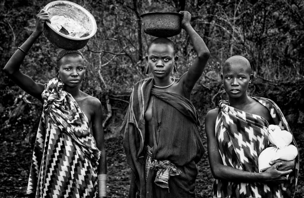 Tribal Women Carrying Bowls by Joxe Inazio Kuesta Garmendia — canvas wall art