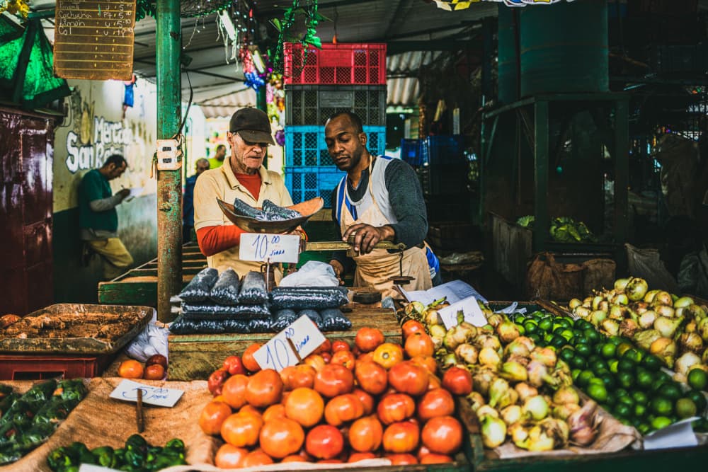 Market Vendors and Produce by Marco Tagliarino — canvas wall art