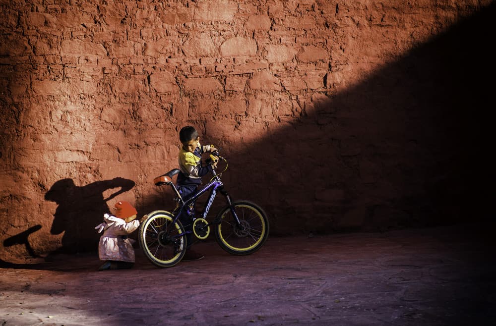 Kids and Bike Shadow Play by John Yuk Kong Chung — canvas wall art