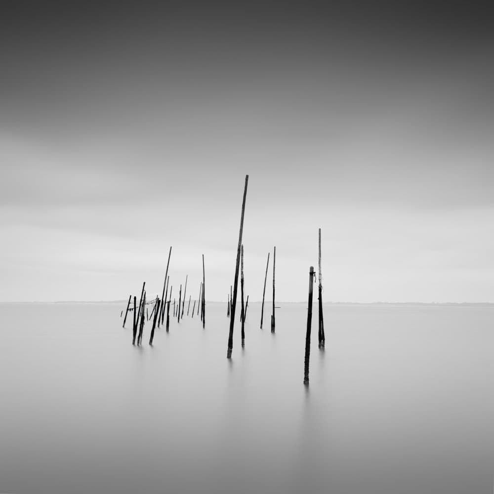 Tranquil Wooden Poles by Christophe Staelens — canvas wall art