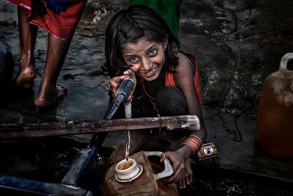 Smiling Girl Fetching Water by Joxe Inazio Kuesta Garmendia — canvas wall art